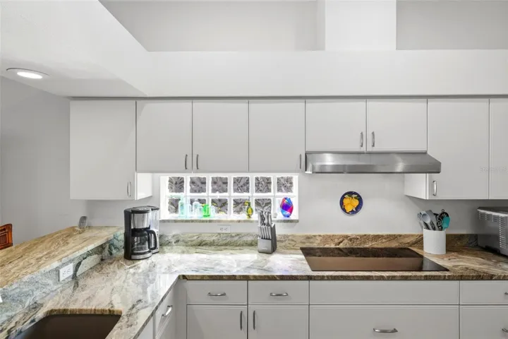 Kitchen with granite counters, glass cooktop