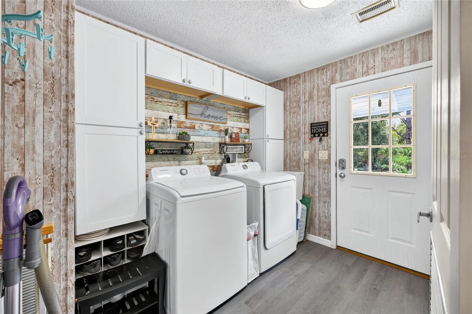 Interior laundry room with rear access from the parking pad