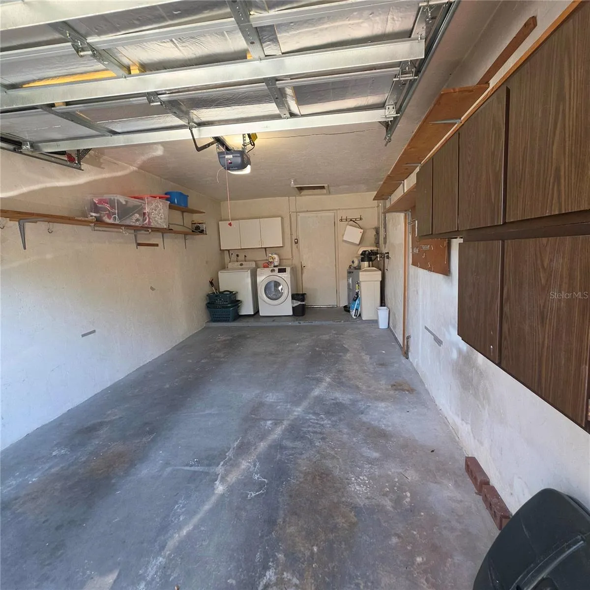 Garage with cabinets and washer and dryer