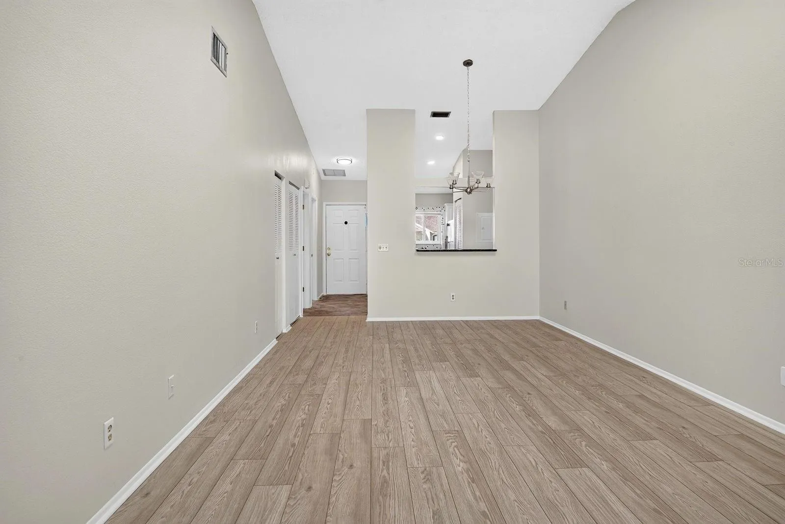 Facing into kitchen from living and dining area