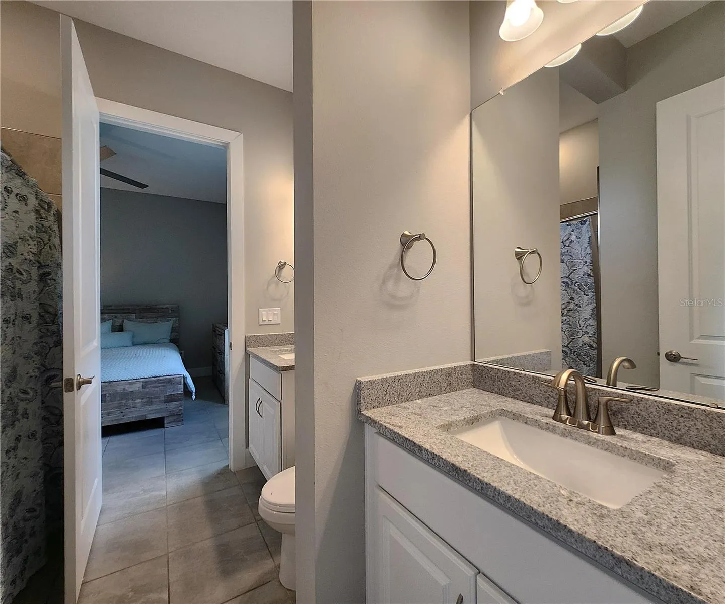 Jack-n-Jill Bathroom includes separate sink vanities, bathtub/shower combo