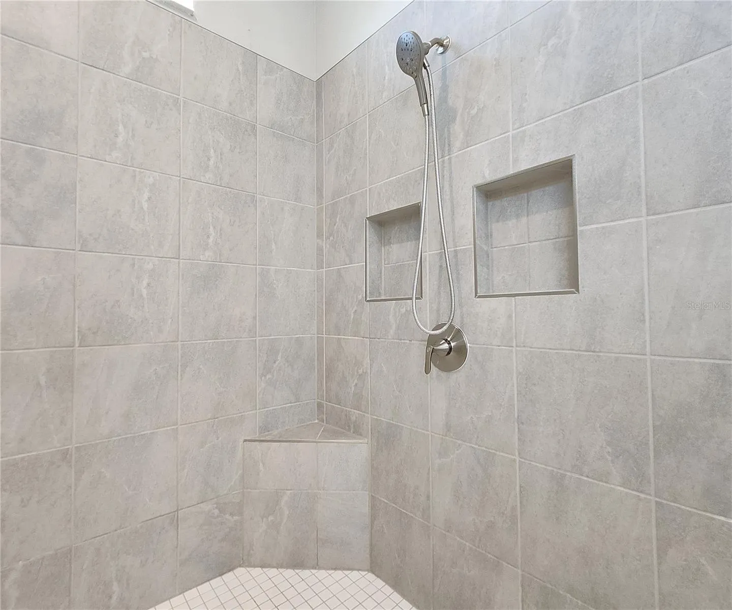Master bathroom includes large walk-in  tiled shower, water closet, walk-in closet, dual sink vanity, granite countertops