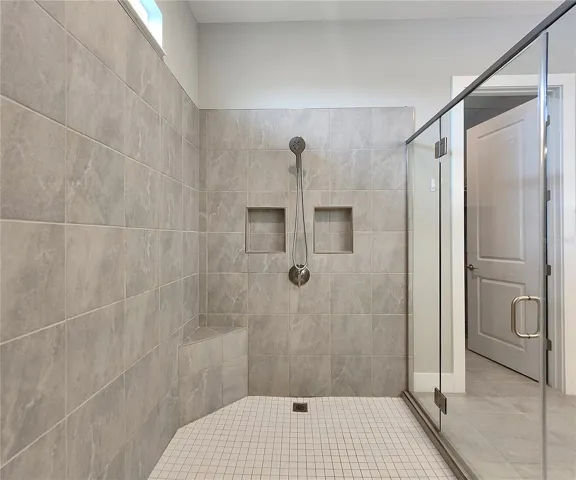 Master bathroom includes large walk-in  tiled shower, water closet, walk-in closet, dual sink vanity, granite countertops