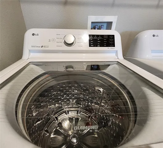 Interior Laundry Room includes side-by-side washer and dryer, ventilated shelves, and storage space