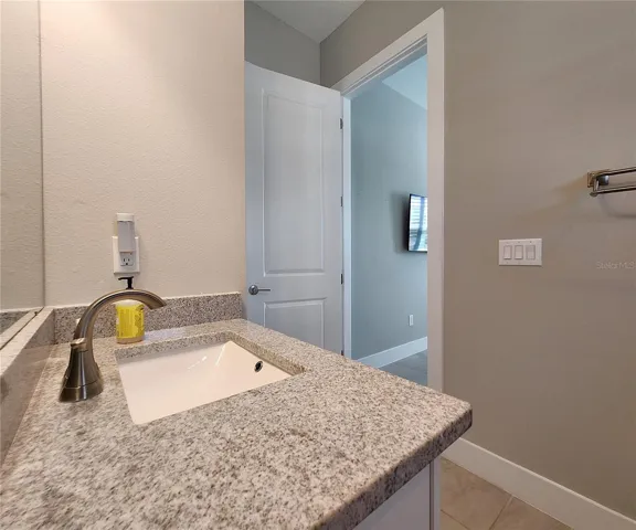 Guest House measures approximately 20x23, includes 1 bedroom, 1 full bathroom, living room, impact glass sliders with remote controlled shades.