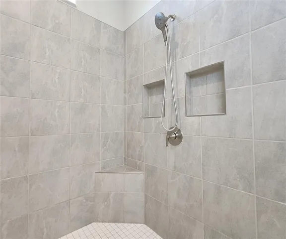 Master bathroom includes large walk-in  tiled shower, water closet, walk-in closet, dual sink vanity, granite countertops