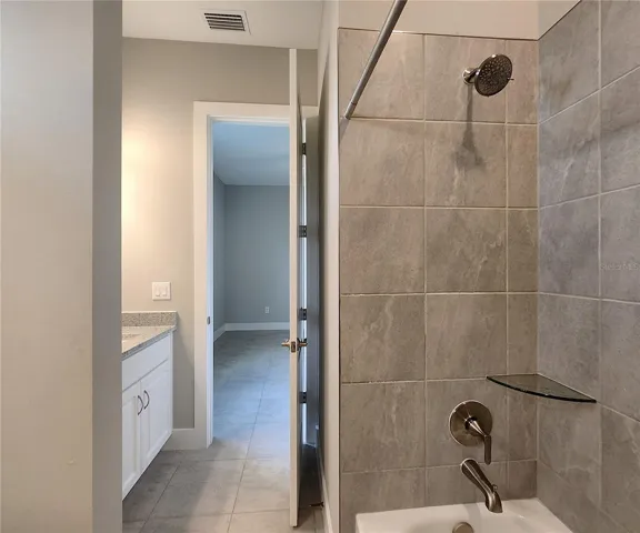 Jack-n-Jill Bathroom includes separate sink vanities, bathtub/shower combo