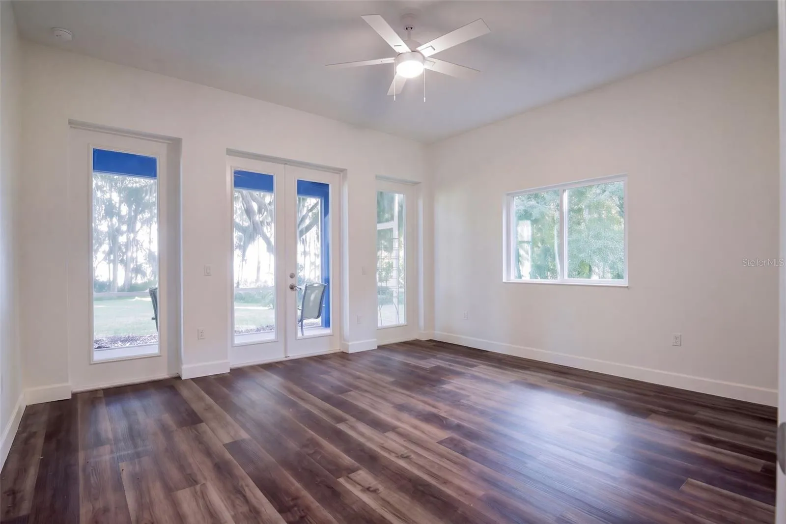 Second bedroom with its own French doors to the porch and lake views