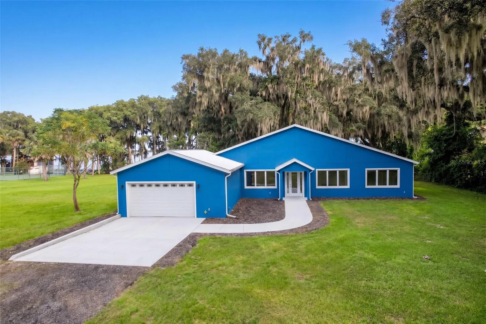 Front of home with 2-car attached garage and wide driveway