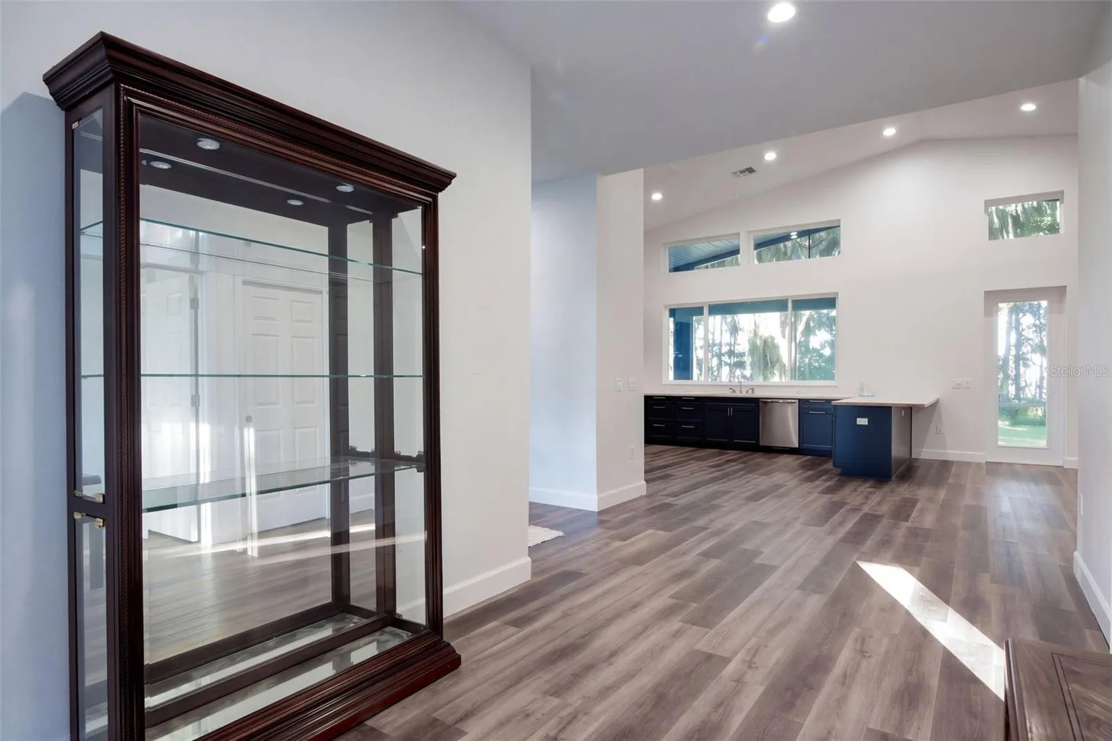 Foyer flows into the open kitchen and great room, with luxury vinyl plank throughout