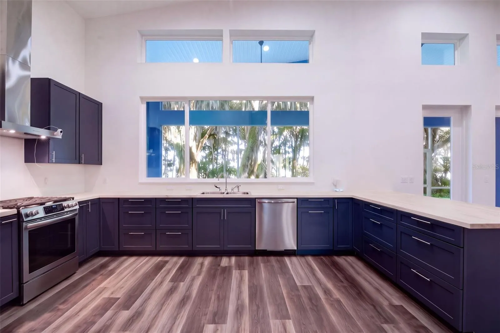 U-shaped kitchen: navy soft-close shaker cabinets and butcher block counters