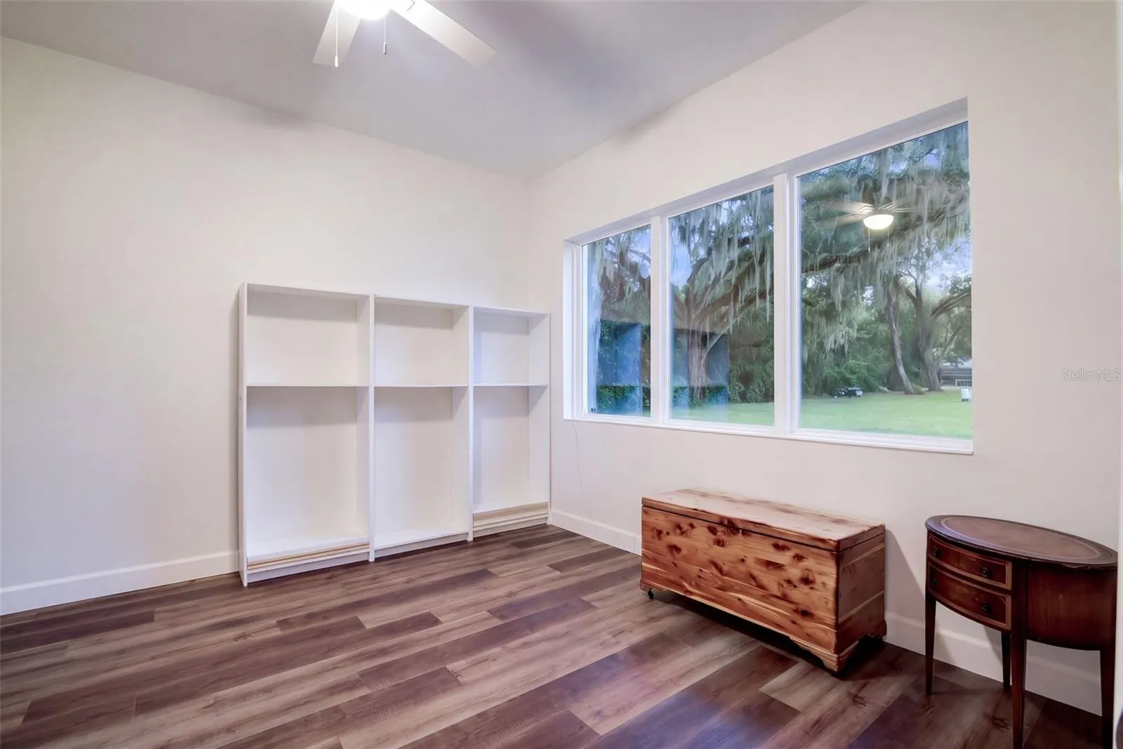 Office/den/possible 4th bedroom with a triple window overlooking the oaks