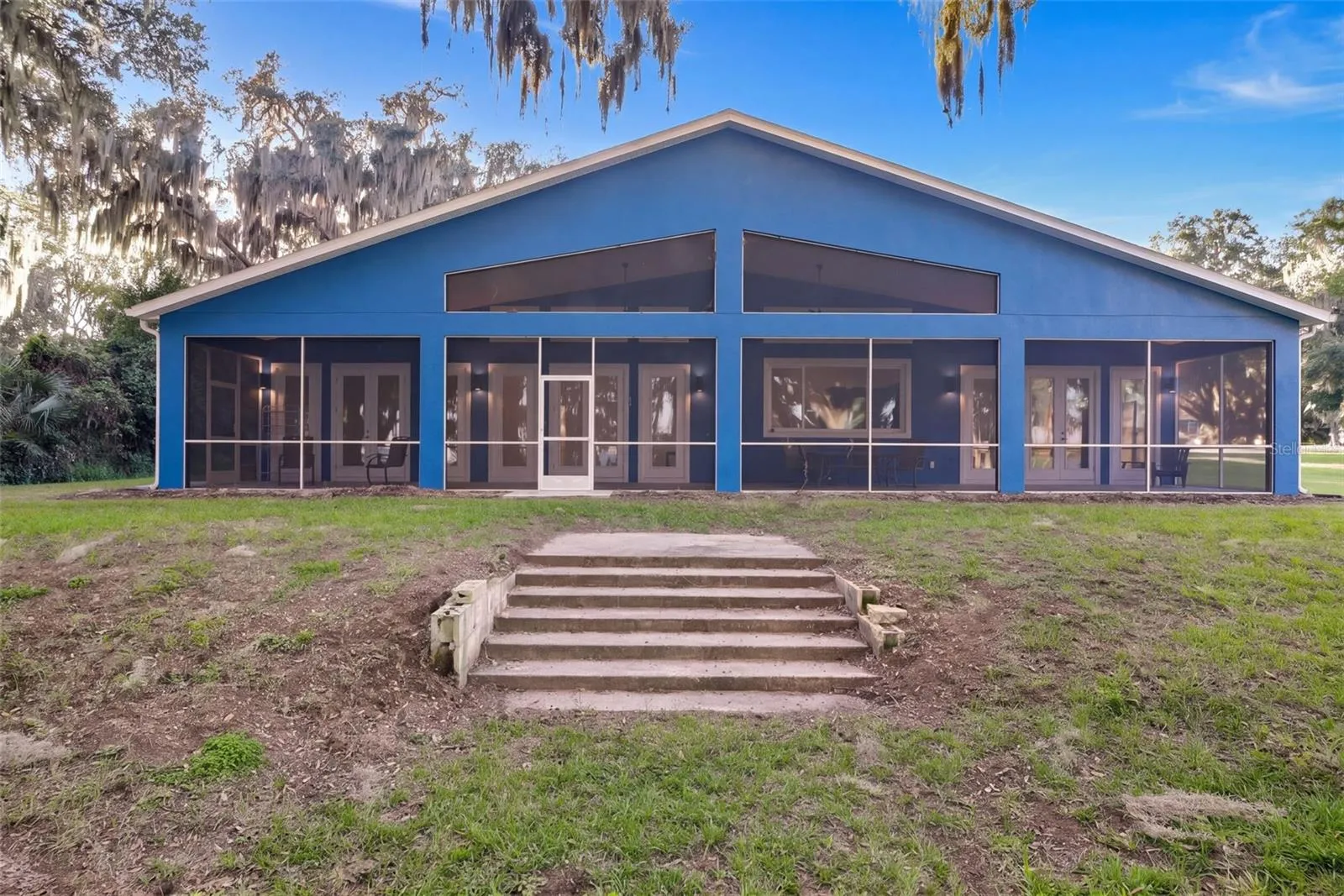 The screened porch runs the full length of the back of the home
