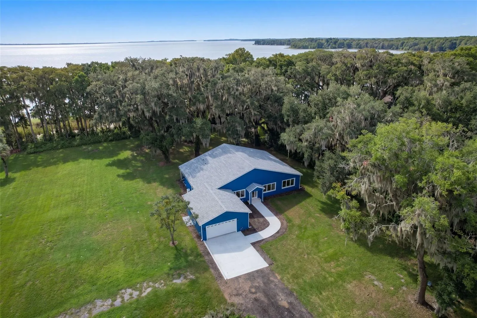 Aerial: custom 2025 home on 1.22 acres with 115 ft of frontage on Lake Harris, Harris Chain of Lakes