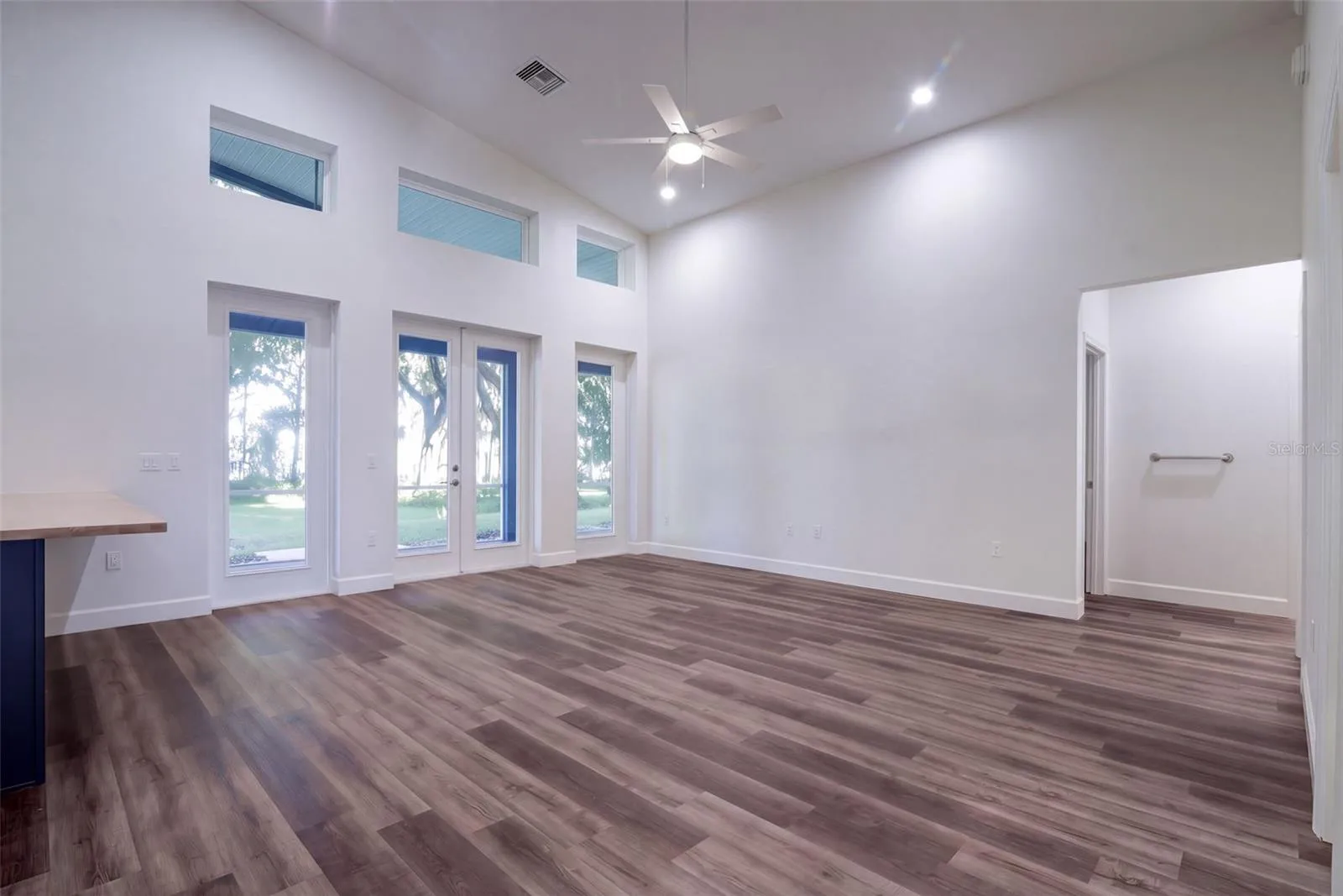 Great room with French doors to the screened porch and views to Lake Harris