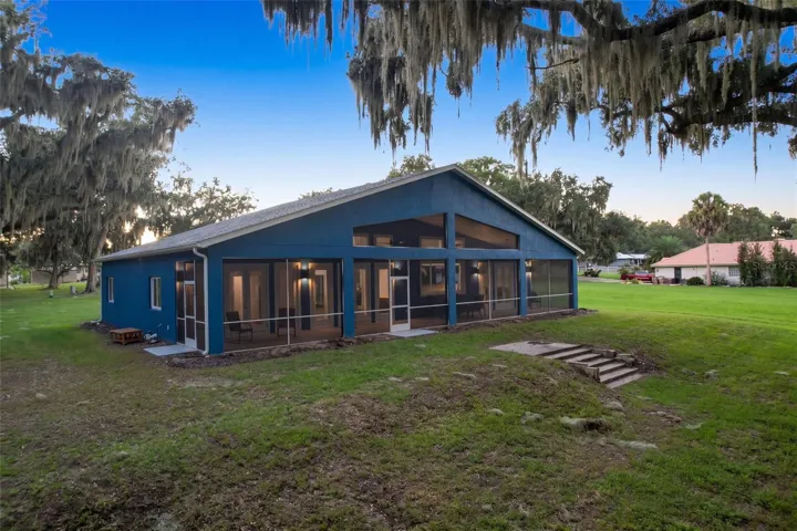 Back of the home: full-length screened porch facing east toward Lake Harris