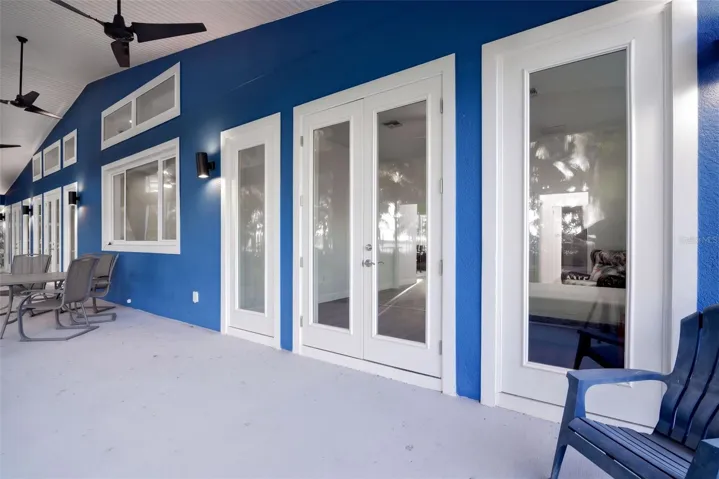 66x10 screened porch with ceiling fans and multiple French door entries