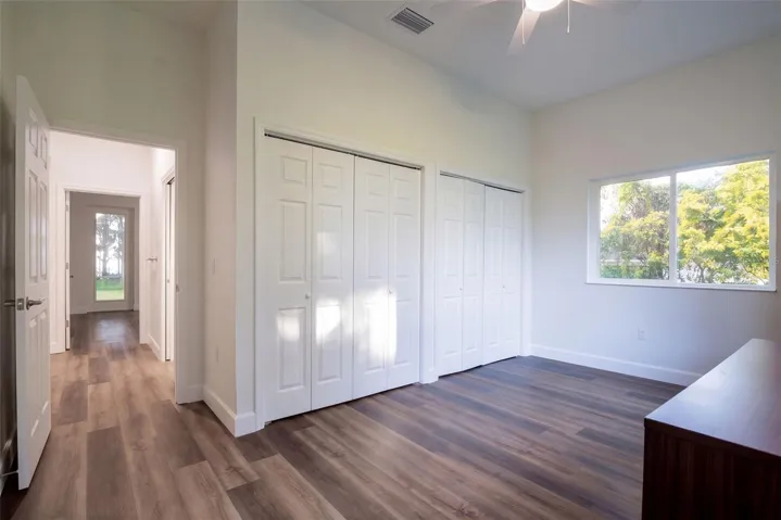 Third bedroom with double closets and a view of the oaks