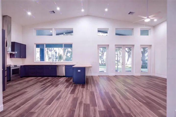 Vaulted kitchen and great room with clerestories, French doors, and lake views