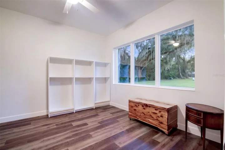 Office/den/possible 4th bedroom with a triple window overlooking the oaks