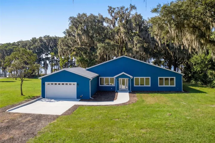 Welcome home: block and stucco, built 2025, set among moss-draped live oaks