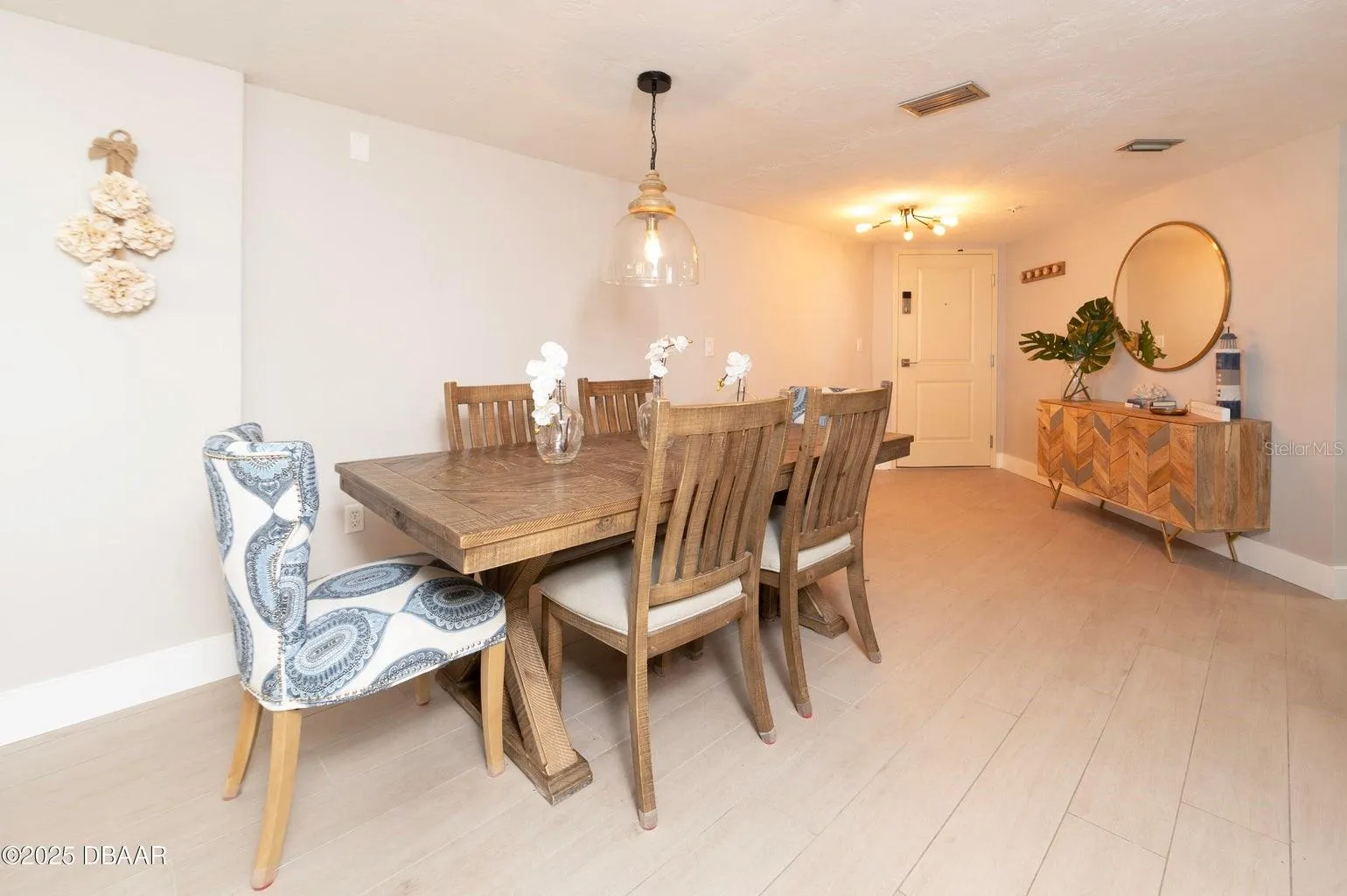 The spacious dining area offers an inviting setting for meals and entertaining, enhanced by contemporary pendant lighting and a seamless connection to the main living spaces.