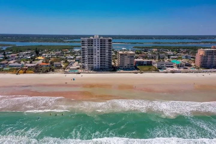 Nestled directly on the sand, this high-rise building boasts unobstructed beach access and expansive shoreline views—ideal for beachfront living.