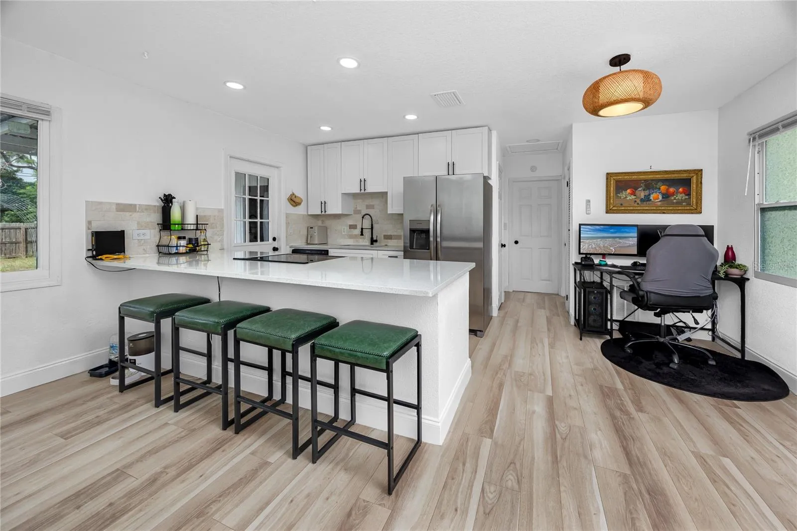 View of the kitchen with breakfast bar and dining room.