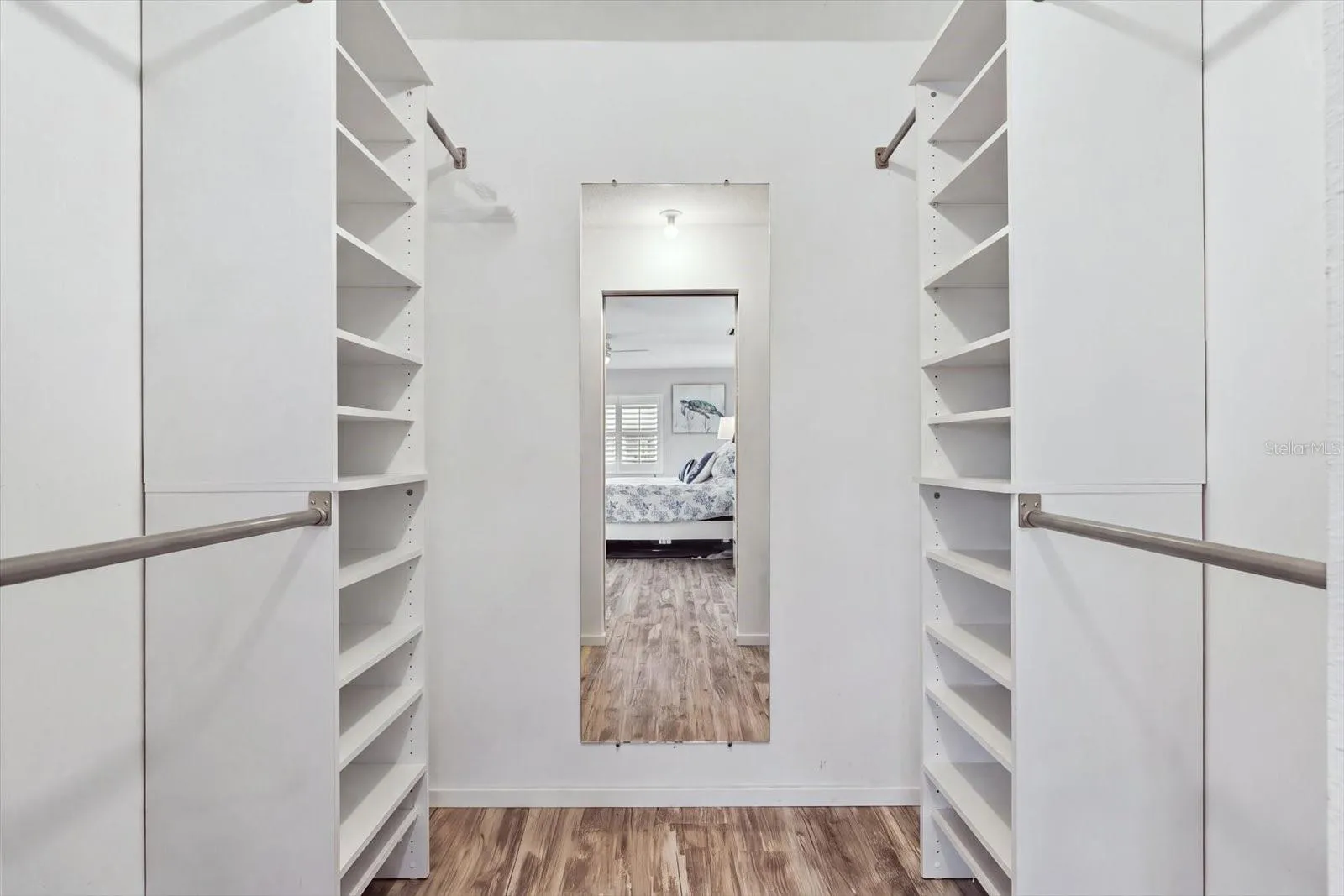 Primary Bedroom Closet with built in shelving