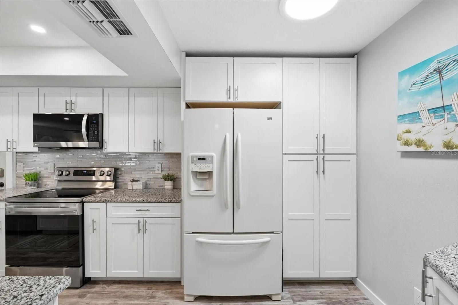 Plenty of storage space and countertops, recessed lighting and solar tube for energy effienciency.