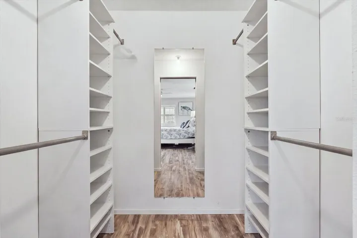 Primary Bedroom Closet with built in shelving