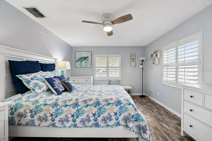 Primary bedroom with plantation shutters.