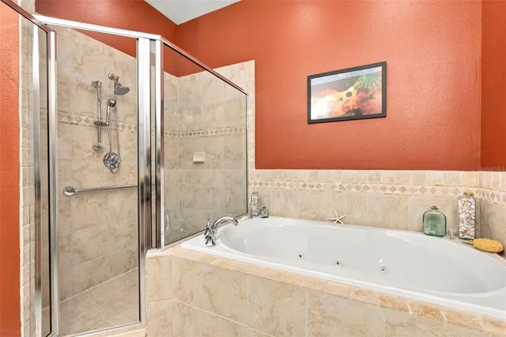 Primary Bedroom with En-Suite Bathroom, His & Her Walk-in Closets, Double sinks with Granite countertops, jacuzzi tub, separate shower