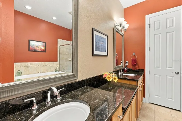 Primary Bedroom with En-Suite Bathroom, His & Her Walk-in Closets, Double sinks with Granite countertops, jacuzzi tub, separate shower