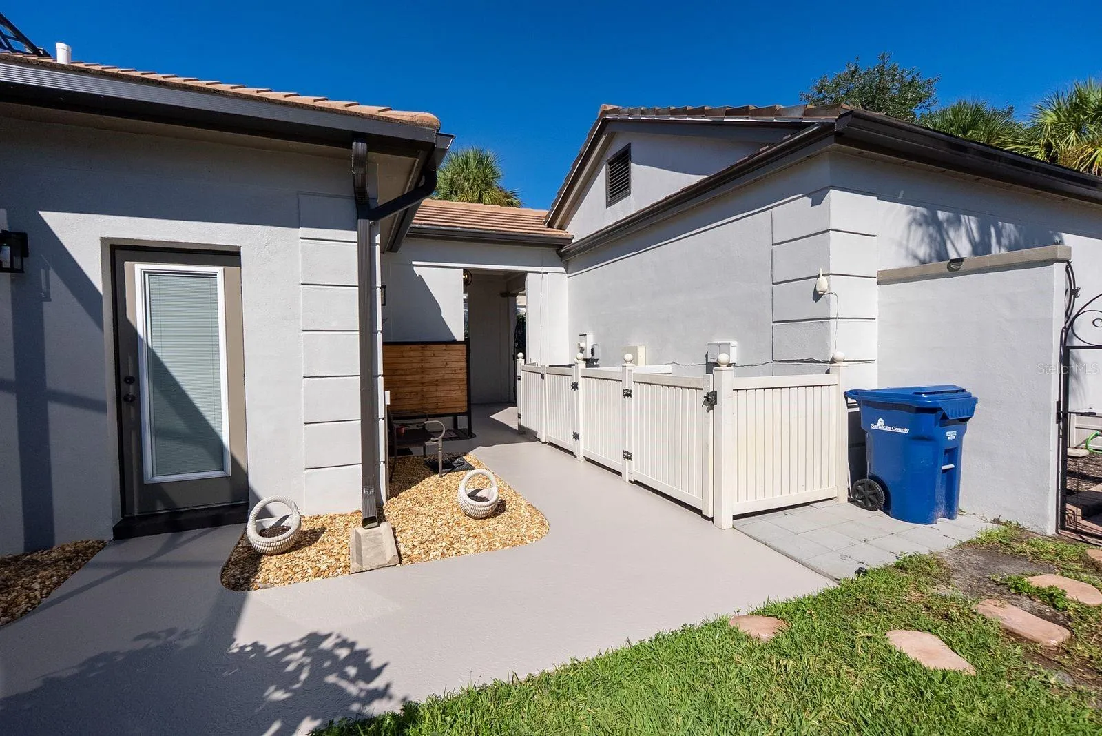 side of house showing door to 1/2 bath