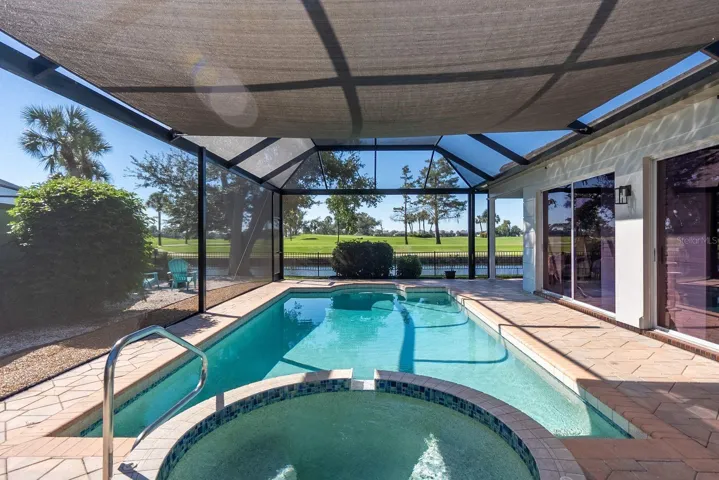 pool and spa overlooking pond and golf course