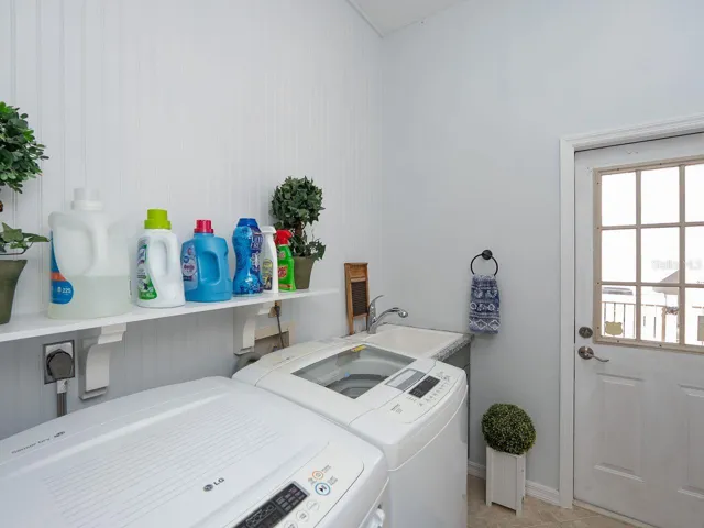 inside laundry room with door to side of house by outside shower
