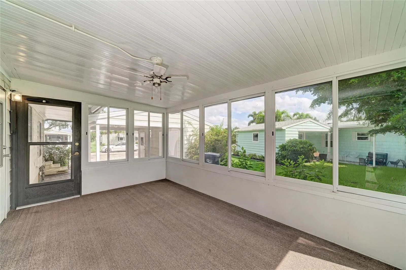 View of sunroom looking out to carport