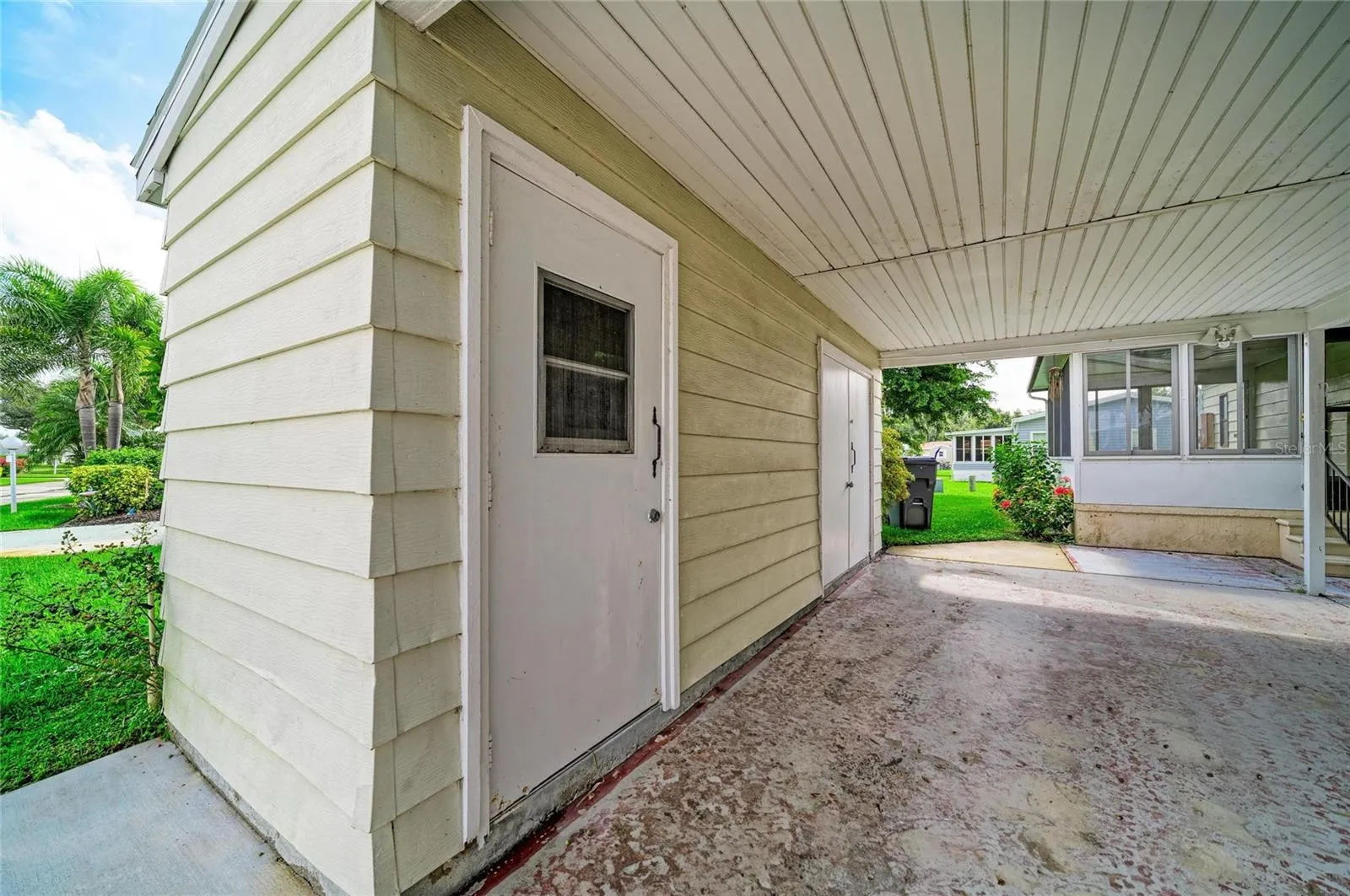 Covered carport with additional storage closet with utility sink