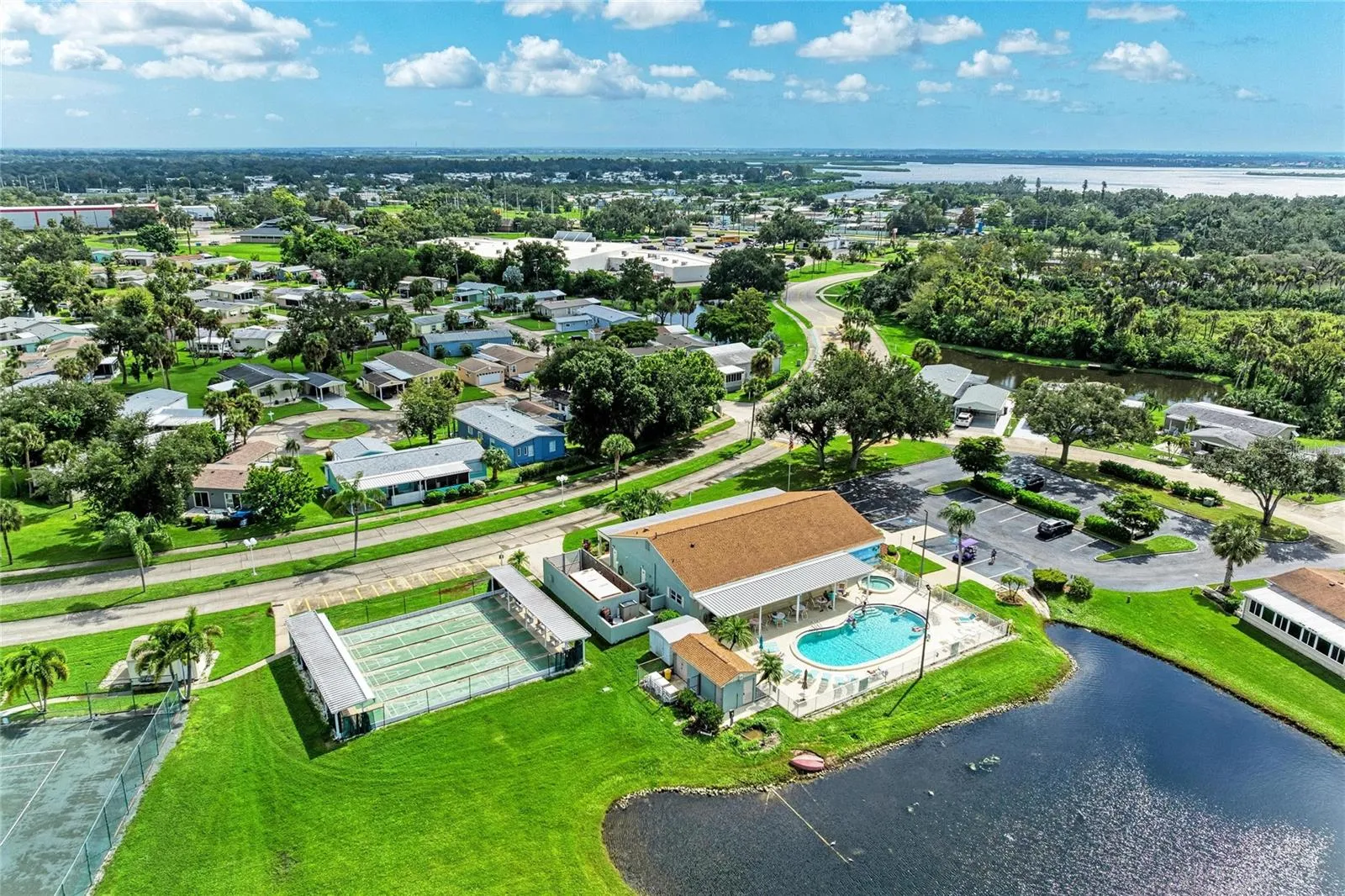 View of clubhouse, shuffleboard courts amd community pool