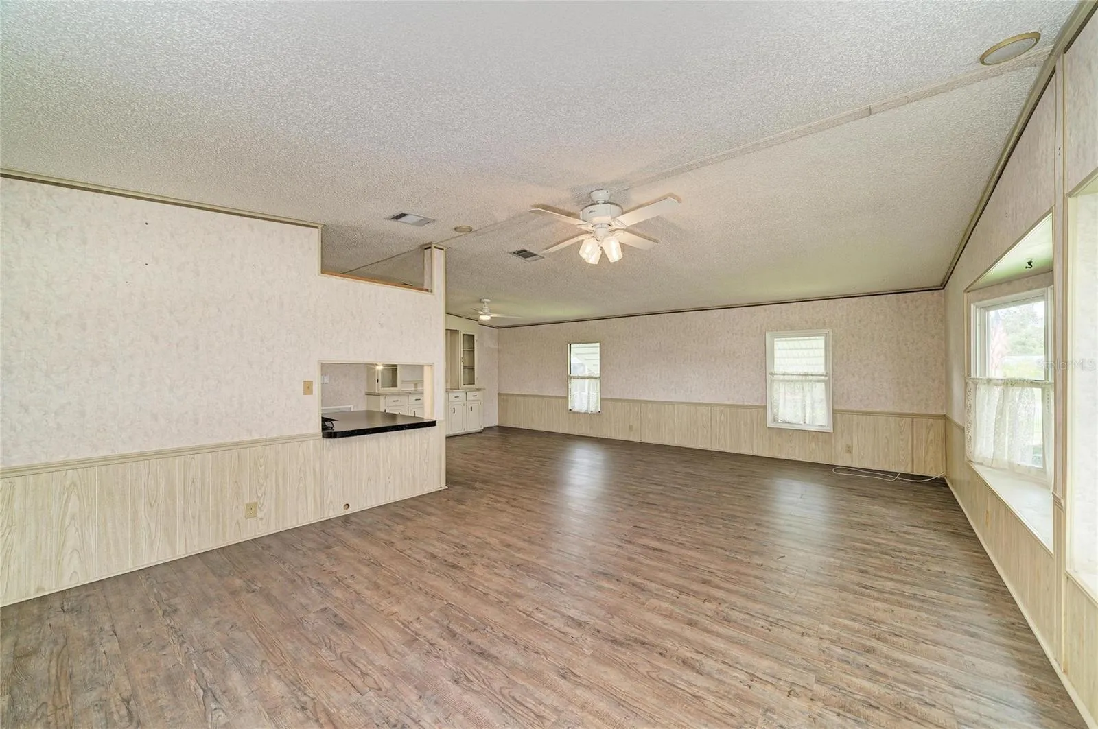 Large great room with laminate flooring. Laminate flooring throughout except bedrooms