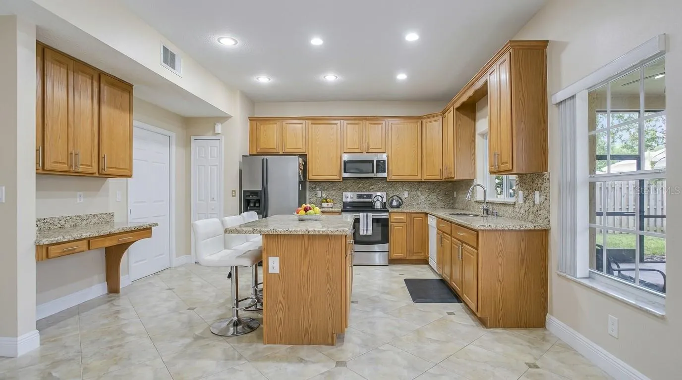 Spacious kitchen view from the dining room, featuring modern finishes and an open-concept layout.