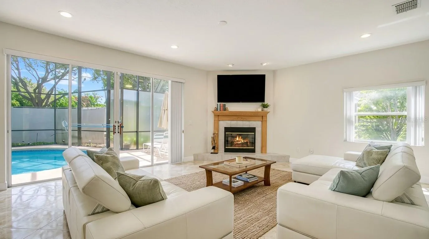 Stunning living room with an open view overlooking the backyard and private pool.