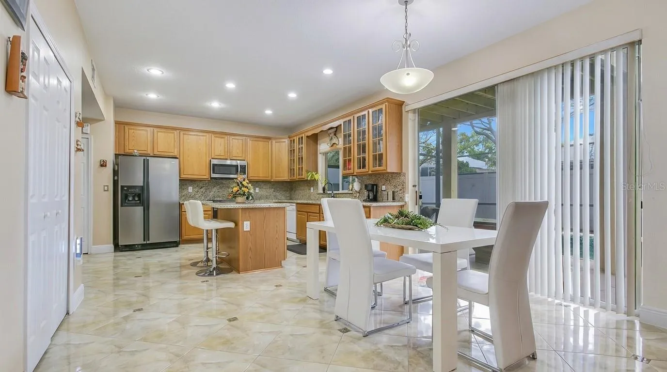 Sliding glass door leading from the kitchen to the pool area.