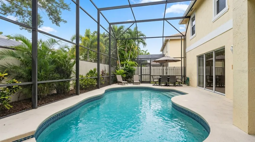 Spacious pool area viewed from the patio entrance.
