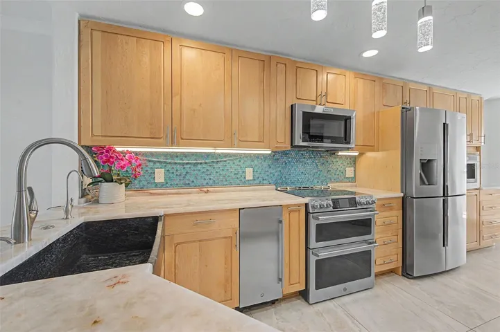 Maple cabinets, quartz counters and tile backsplash