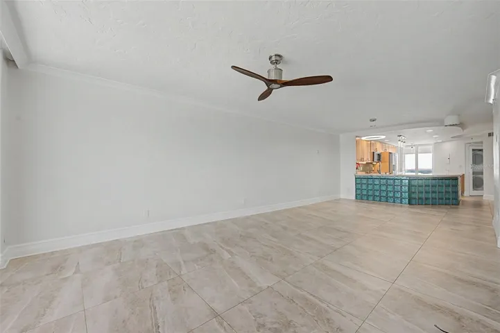 Step back in from the balcony to the Living area and looking into the kitchen.