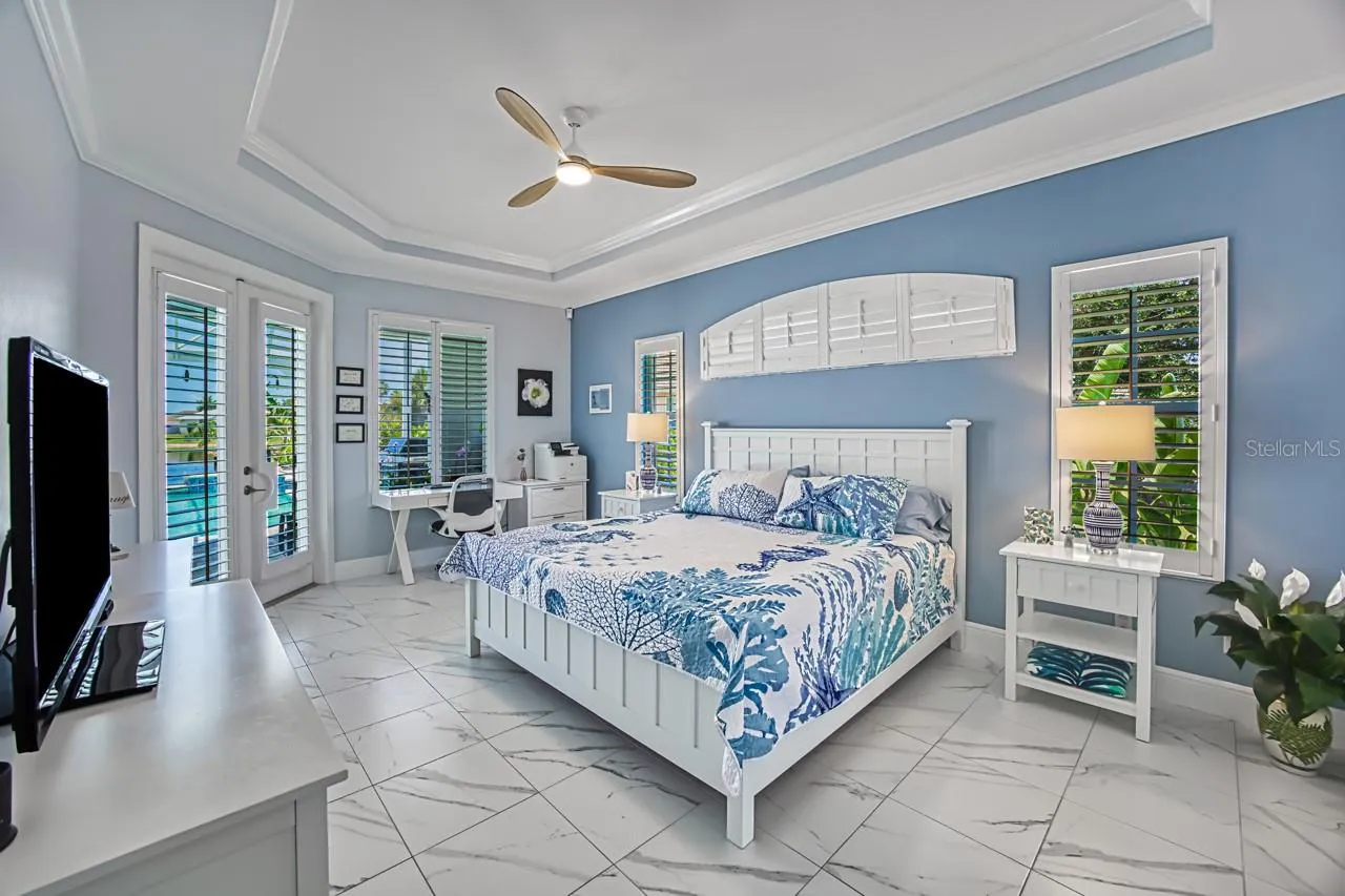 Primary Suite with French doors out to lanai/pool area