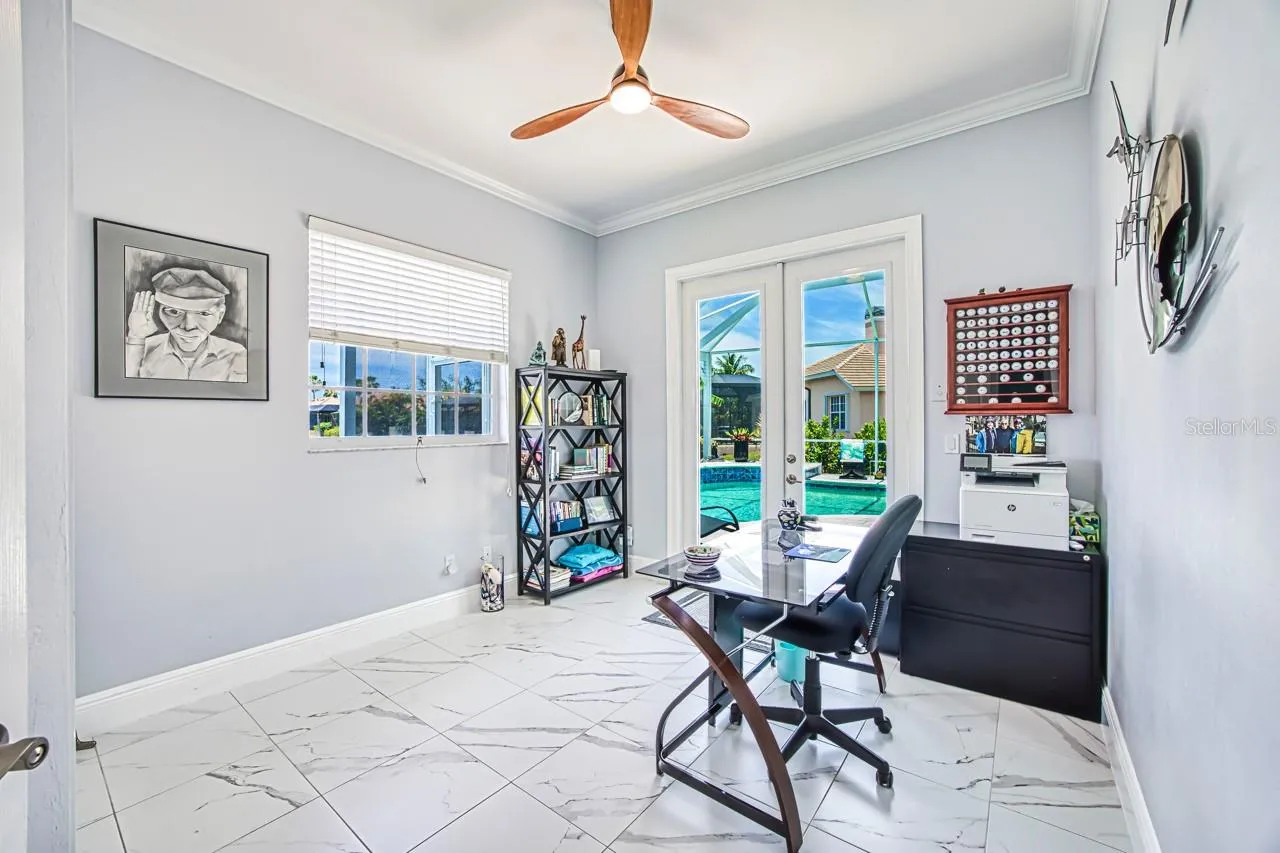 4th bedroom with hurricane french doors opening to pool area - also has fabric hurricane shutters for added protection
