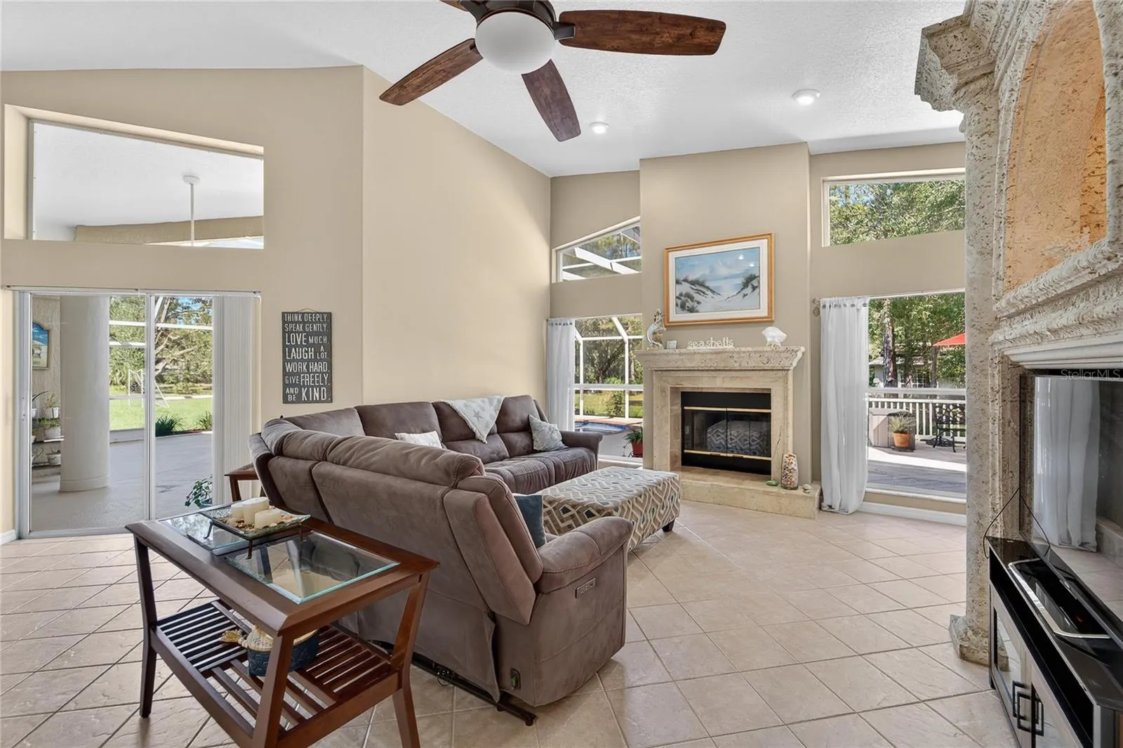 Family room is open to the kitchen, overlooks the pool and has a wood burning fireplace